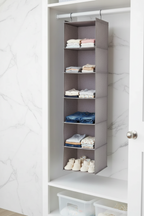 Whitmor 6-section hanging shelves light grey in minimalist white nursery closet with baby clothing neatly folded in compartments