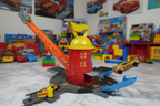 Assembled Hot Wheels City Super Fire Station Rescue with red tower, yellow dome, orange ramp, and gold rescue car launching from exit point