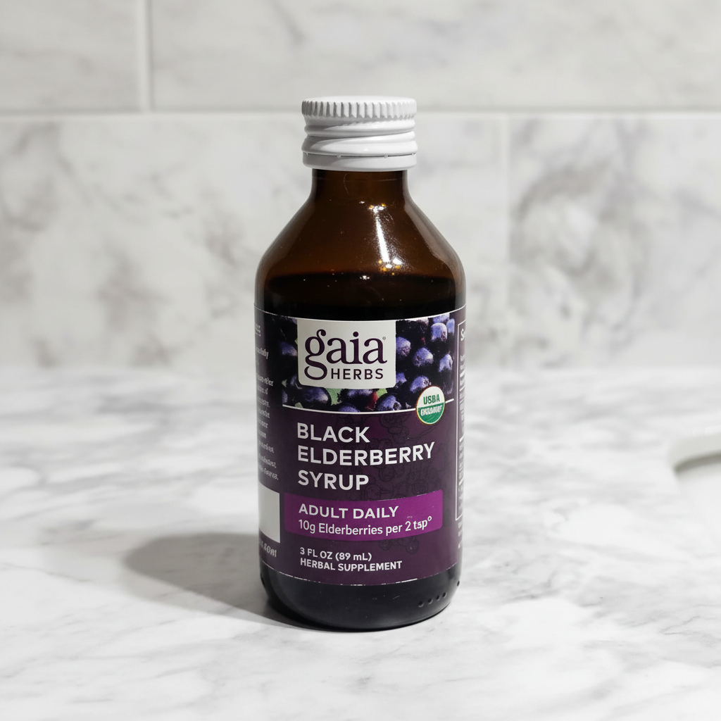 Gaia Herbs Black Elderberry Syrup bottle upright on a white marble bathroom counter