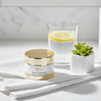 RoC Multi Correxion Revive + Glow Gel Cream on white linen with lemon water and succulent flatlay.
