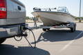 Hopkins Endurance and CURT 7-way towing connection kit installed on truck hitch with boat trailer in parking lot - More4less Outlet