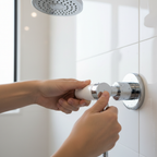 Close-up hands turning polished chrome lever shower handle with white ceramic insert