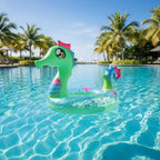 PoolCandy Glitter Seahorse pool tube floating in tropical resort pool palm trees