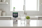 Focus Factor Extra Strength box in kitchen wellness setup with glass of water