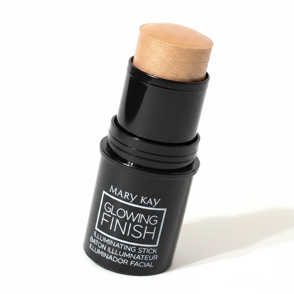 Close-up macro of Mary Kay Glowing Finish Illuminating Stick Gold — glossy black twist-up casing with cream golden-bronze shimmer highlighter bullet fully extended on a clean white background with soft warm lighting catching the metallic shimmer