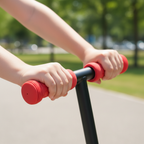 Child's hands gripping red foam handlebar grips on black scooter — Mongoose Force 1.0 soft grip feature — More4less Outlet