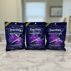 DenTek Plaque Control Cross Flosser 75-count three-bag pack on a neutral vanity