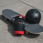 G-Form Youth Pro-X2 Knee Pads flat lay on concrete skate park with skateboard and helmet