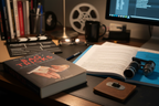 The Film Director's Bag of Tricks by Mark W. Travis on filmmaker's desk with clapperboard screenplay and director's viewfinder – More4less Outlet