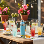 Festive outdoor patio table with powder blue cocktail shaker alongside chilled drinks with colorful straws and stirrers