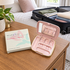 AI-generated travel-packing scene of an empty Mary Kay Custom Compact and box beside a bed