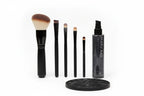 Studio high-key shot of cosmetic brush maintenance equipment with professional makeup brushes and spray cleaner