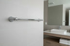 Professional hardware install setup focusing on polished chrome metallic towel bar in a modern washroom