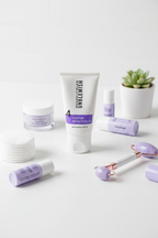 Rodan and Fields UNBLEMISH Invisible Matte Defense SPF 30 tube flat lay on white surface with purple skincare props and cotton pads – More4less Outlet