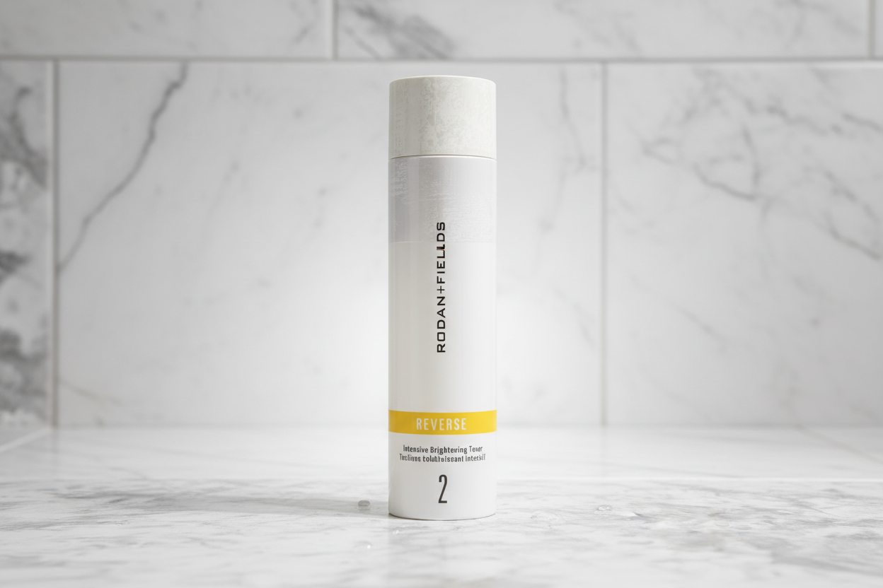 Rodan + Fields REVERSE Intensive Brightening Toner bottle on high-end white bathroom tile with radiant soft light