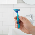 Gillette Sensor2 Plus blue razor held by man's hand in modern bathroom with white subway tile – More4less Outlet