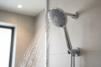 Grohe Euphoria 110 Duo polished chrome hand shower dual spray jets action shot in modern master bathroom renovation
