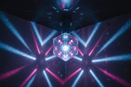 Faceted disco LED light bulb casting blue and pink multicolor patterns across dark walls