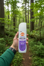 Person holding OFF! Clean Feel Insect Repellent on hiking trail surrounded by lush green forest
