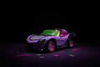 Purple Monster High Ghoul Mobile toy convertible car with spiderweb wheels and neon green windshield on a dark purple surface with bat and star decorations.