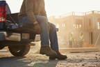 Worker pulling on Timberland PRO Excave boots using pull tab at truck tailgate — convenient pull-on entry for quick on-site use