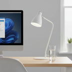 GE Link A19 Connected LED Bulb installed and glowing in modern minimalist desk lamp on home office workstation with monitor and glass of water
