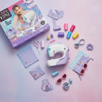 Cool Maker Stitch N Style Fashion Studio by Spin Master on a pastel pink and purple flat lay with fabric swatches, thread, scrunchie, and mini purse accessories – More4less Outlet