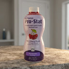 Nutricia Pro-Stat specialized clinical nutrition liquid protein bottle on natural stone surface, warm side lighting