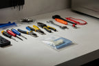 Professional appliance maintenance tools arranged beside a packaged OEM replacement part on a clean workbench