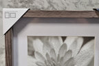 Close-up interior detail shot showing textured wood-grain frame finish and white matting