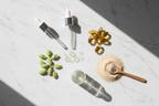 Glycerin drops pea protein pods vitamin E capsules and yeast amino acids flat lay curl care ingredients lifestyle photo