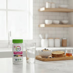 Rainbow Light Women's One Multivitamin bottle on minimalist kitchen breakfast bar with glass of water and whole-grain breakfast tray