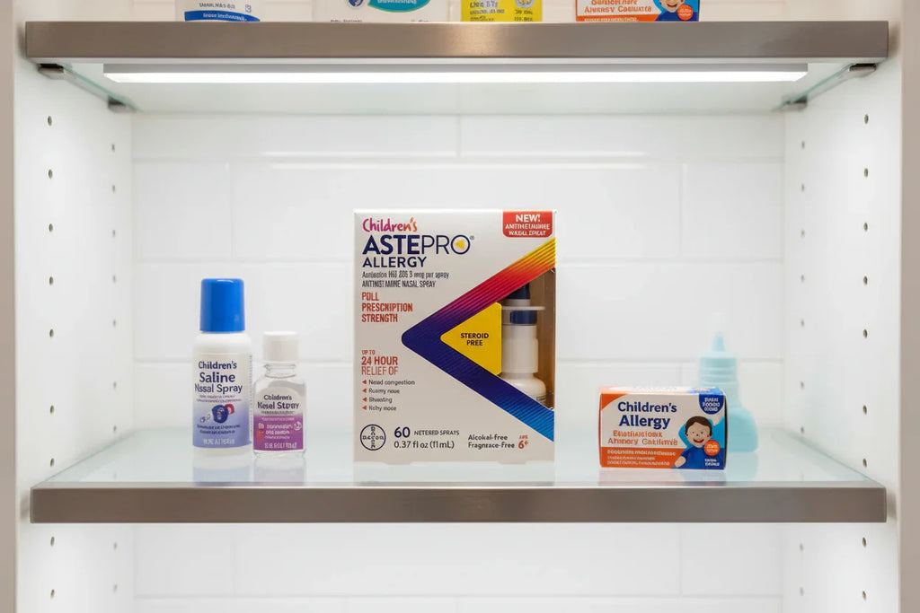 Modern medicine cabinet shelf with Children's ASTEPRO Allergy nasal spray organized with other essentials