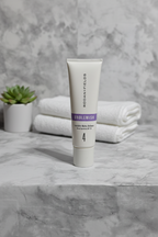 Rodan and Fields UNBLEMISH Invisible Matte Defense SPF 30 sunscreen tube on a marble bathroom counter with soft natural light and small green plant – More4less Outlet