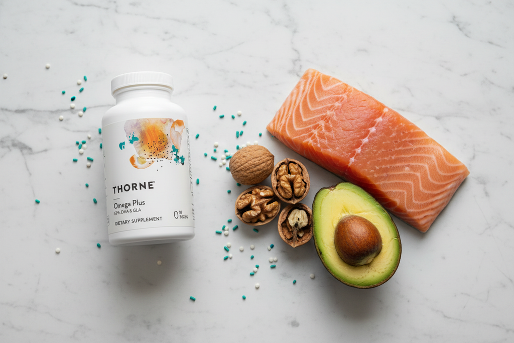 White supplement bottle on marble next to fresh salmon, walnuts, and avocado, omega-3 heart health wellness