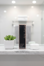 Mary Kay Reviving Facial Spray box on white marble bathroom shelf with small plant and cotton pads