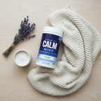 Natural Vitality Calm Mind magnesium supplement flat lay with lavender and candle