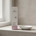 Arbonne TrueSmooth Apple Vinegar Hair Rinse 5 fl oz package on a neutral shelf beside a folded towel