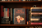 The Film Director's Bag of Tricks by Mark W. Travis on bookshelf with filmmaking and screenwriting books – More4less Outlet