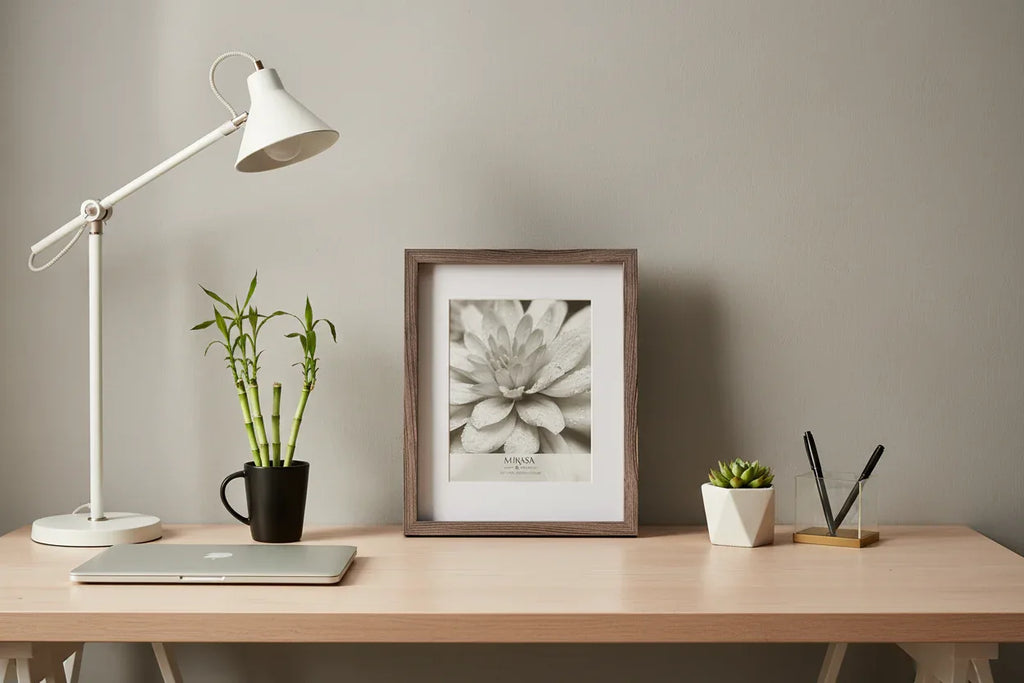 Minimalist home office desk accessory display featuring portrait orientation frame