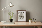 Minimalist home office desk accessory display featuring portrait orientation frame