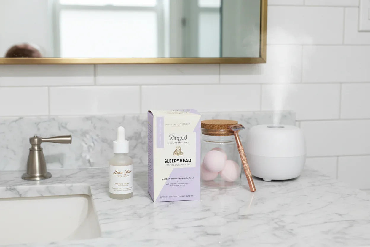 Marble bathroom vanity with Winged Women's Wellness Sleepyhead supplement box