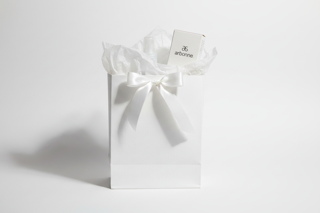 Arbonne TrueSmooth Apple Vinegar Hair Rinse bottle and box as premium clean beauty gift in white gift bag with ribbon – More4less Outlet