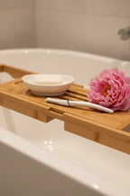 Gillette Venus facial razor on spa bath tray with peony and porcelain soap dish