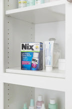 Nix Lice Killing Creme Rinse 2oz in white apothecary cabinet with family bathroom essentials — More4less Outlet