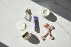 Top-down flat lay of a morning skincare routine featuring orbital care products including LUMIFY Eye Cream in natural daylight