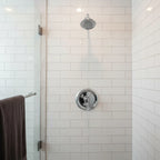 Moen Dartmoor chrome shower trim installed in luxury shower with white subway tile lifestyle image