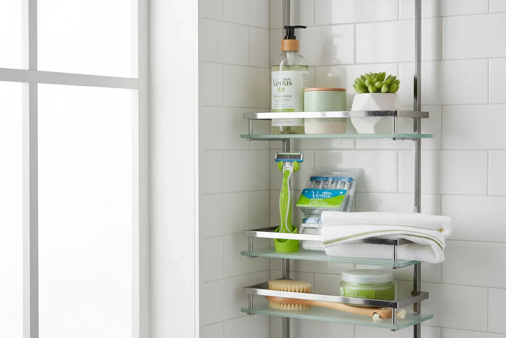 Minimalist modern shower caddy arrangement holding premium bath and body grooming items with green accents