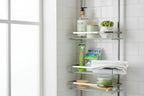 Minimalist modern shower caddy arrangement holding premium bath and body grooming items with green accents