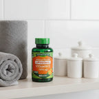 Nature's Truth Liposomal Vitamin C 1650mg bottle on minimalist bathroom shelf with grey face towel and white apothecary jars